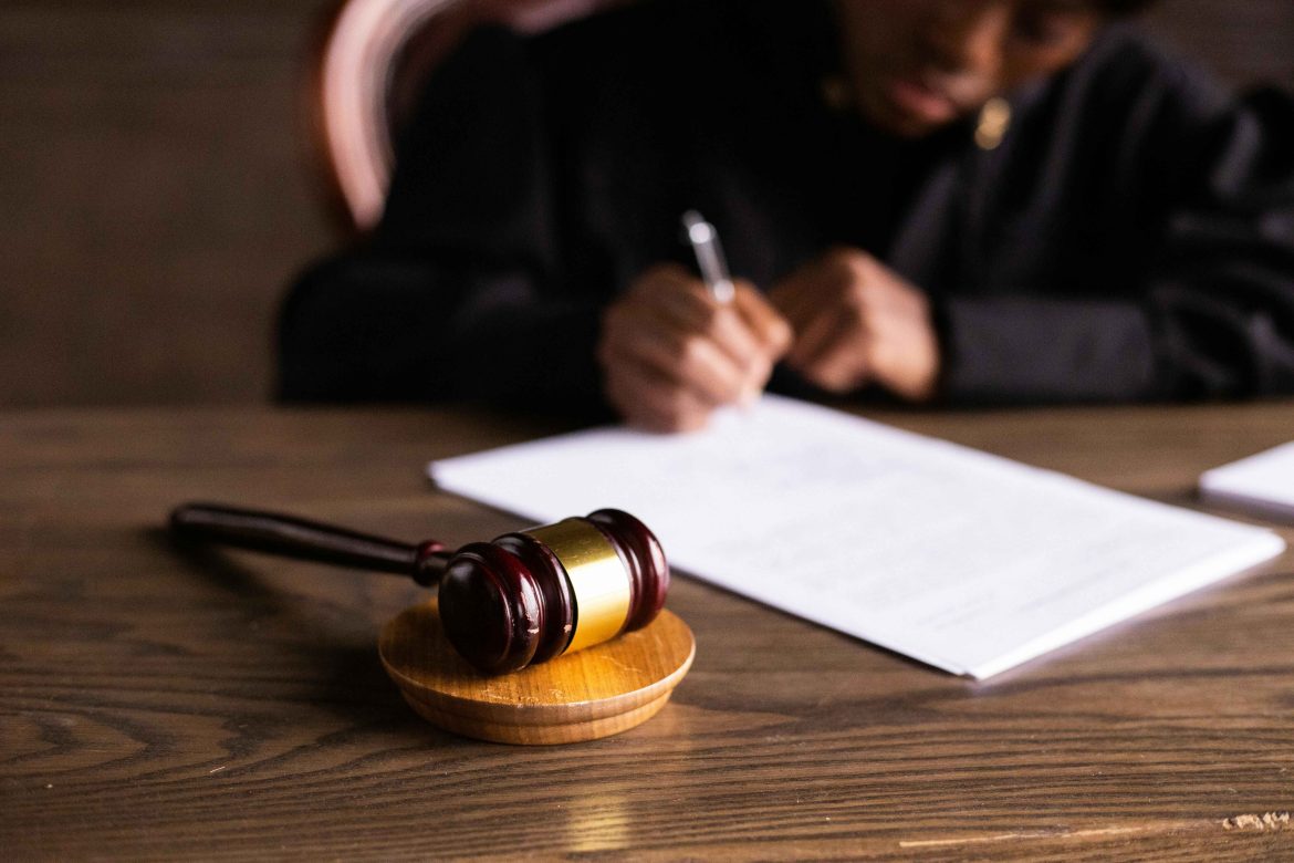 Person signing paperwork at a table.